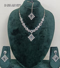 Silver-toned jewelry set displayed on a dark green velvet mannequin bust, including a necklace with a large central pendant, matching earrings, and a small matching pendant on a chain,